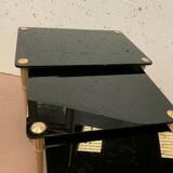 Pull out tables in brass and black glass XX century
