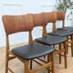 Set of 4 Danish chairs in teak and black faux leather, 1960s.