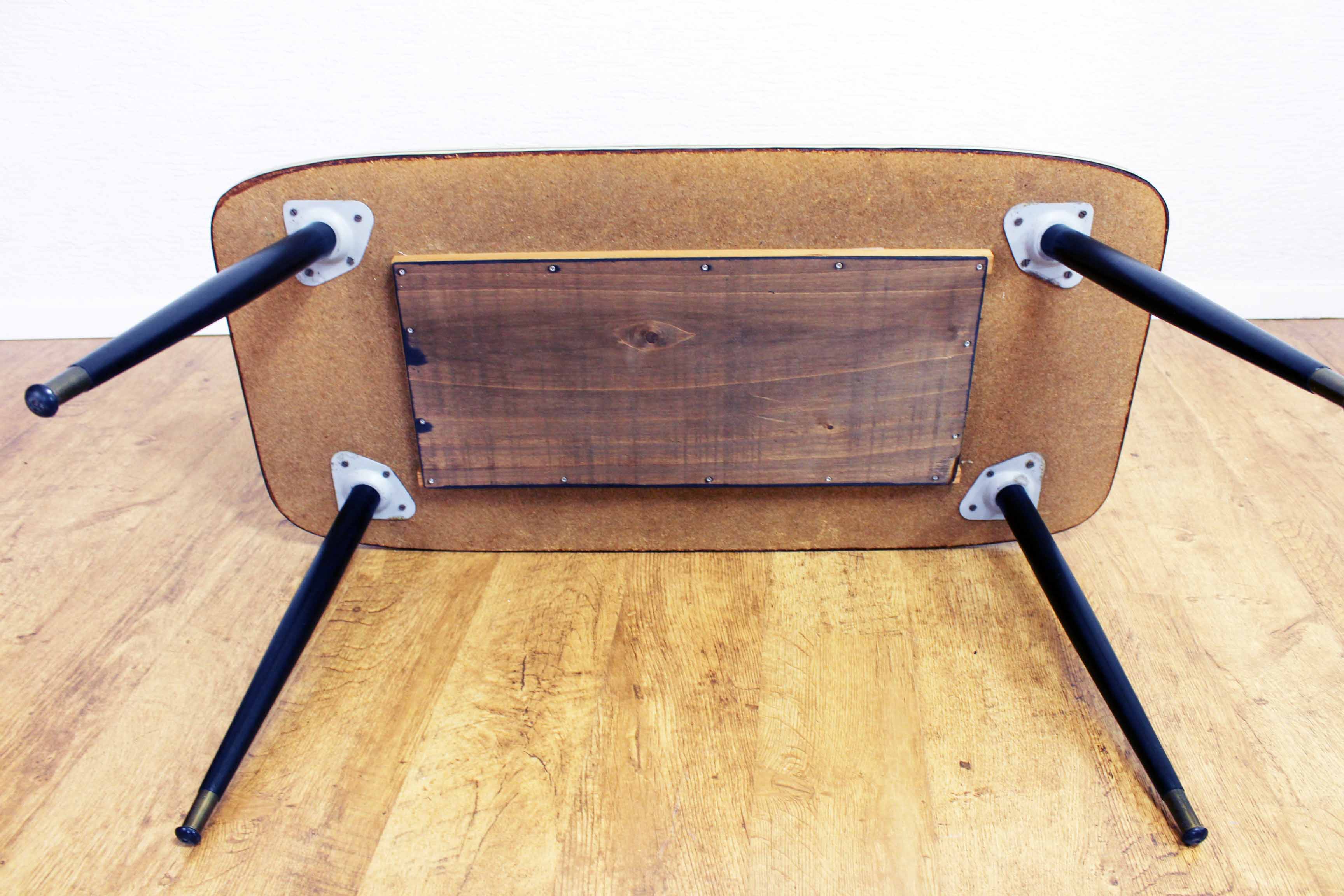 Low table with compass feet with decorative cabinet