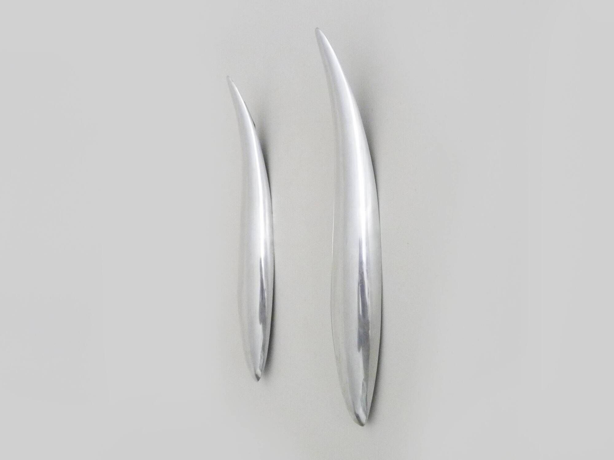 Pair of designer wall sconces in aluminium in the style of Lucien Gau.