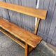 Brutalist bench with dark wood back