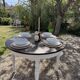 Restored solid wood round table with integrated extensions.