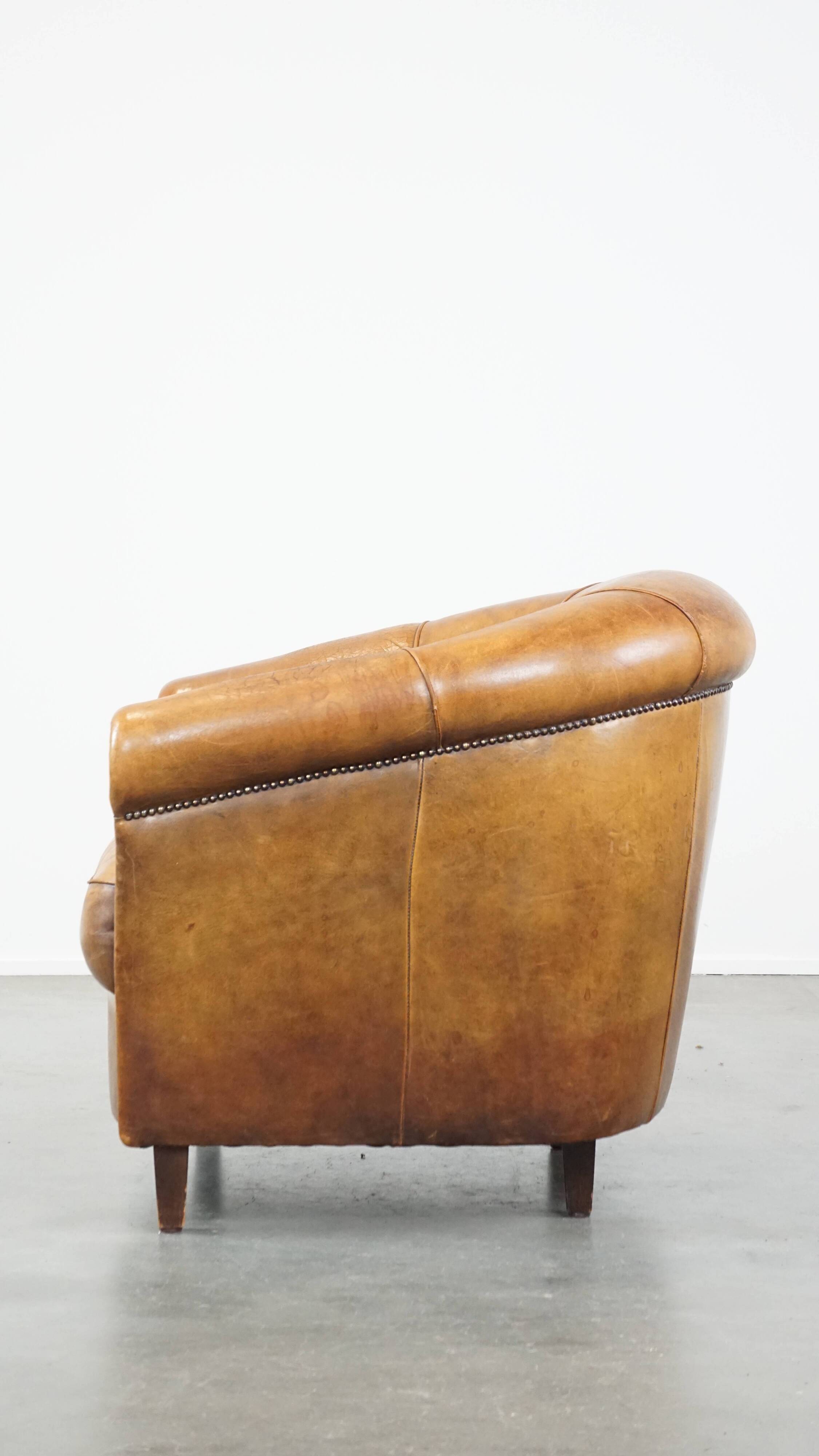 Cognac-colored sheep leather club chair with patina