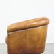 Cognac-colored sheep leather club chair with patina