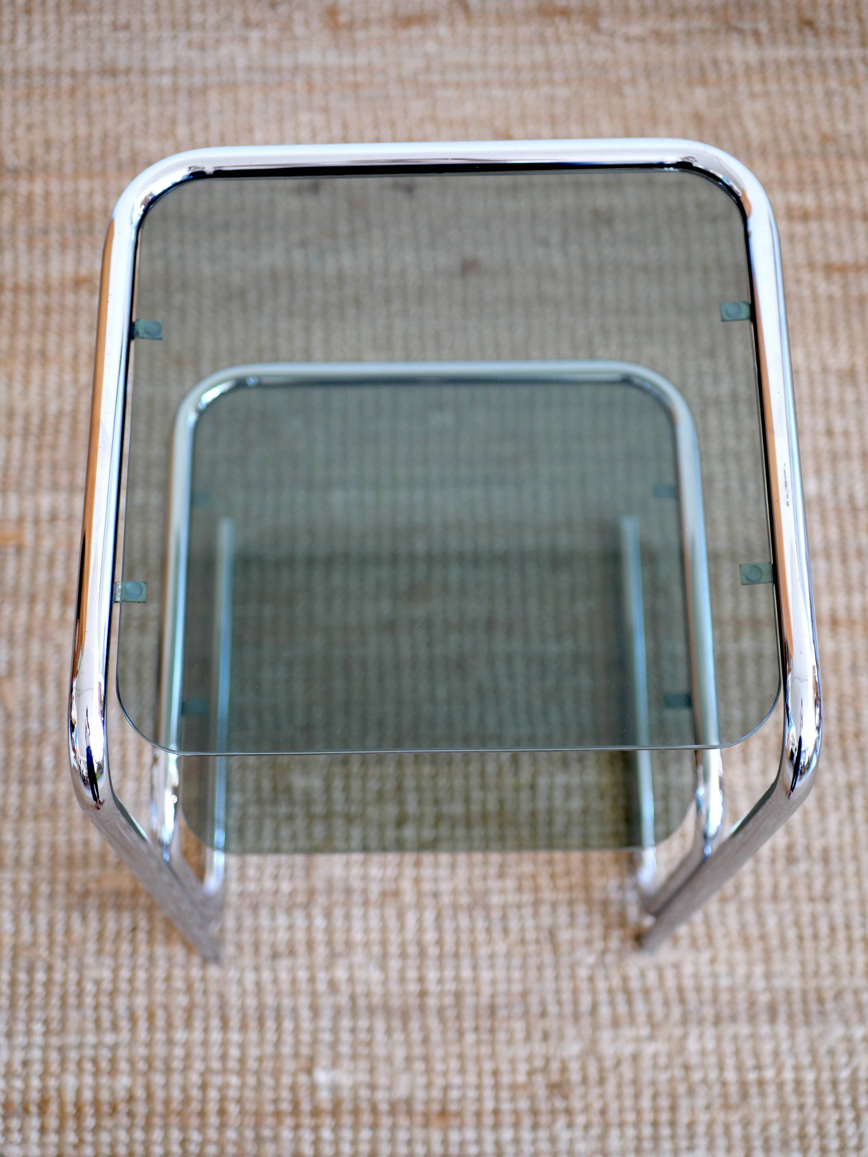 Glass-topped side table with tubular metal.
