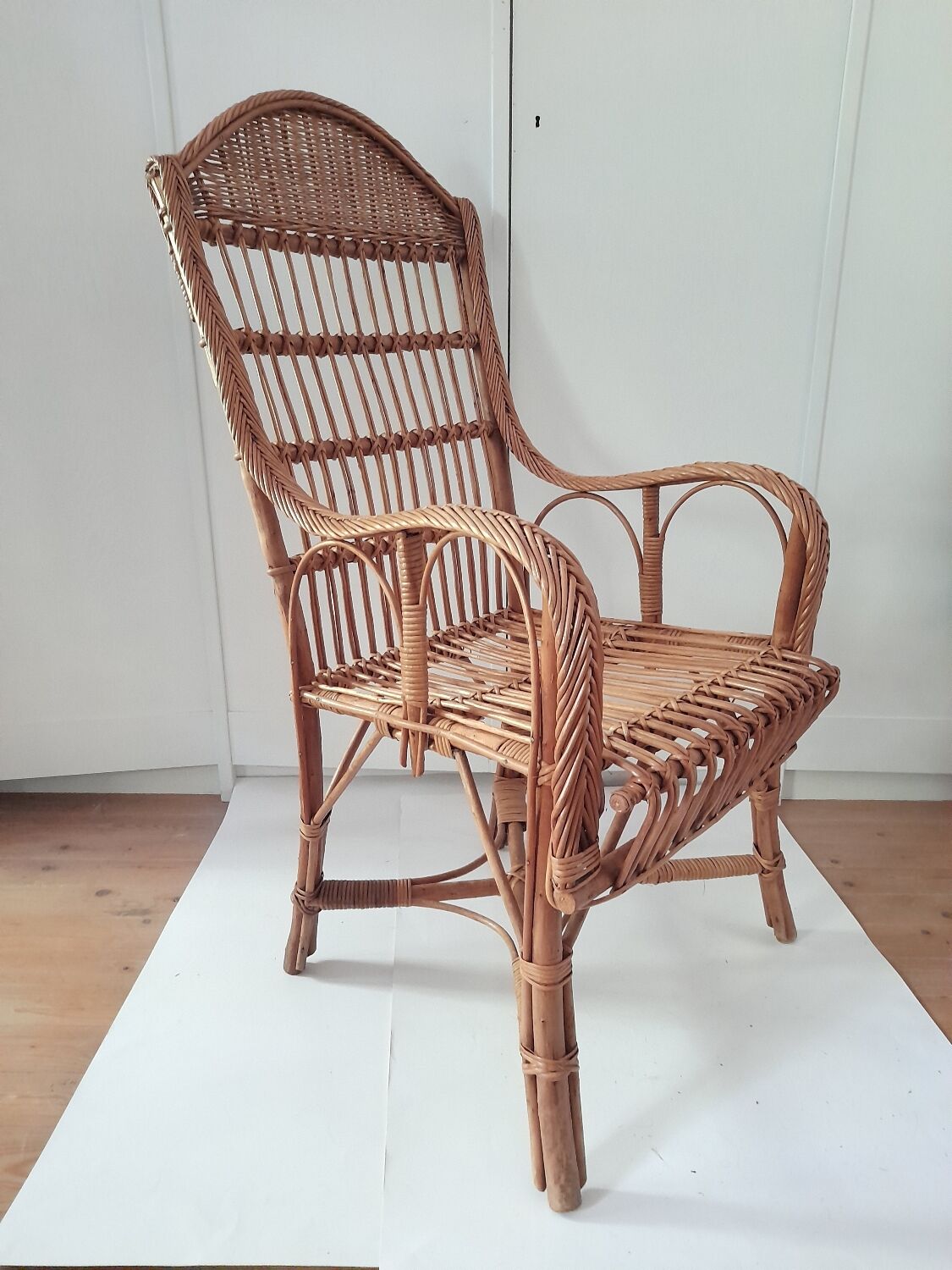 High-backed wicker armchair