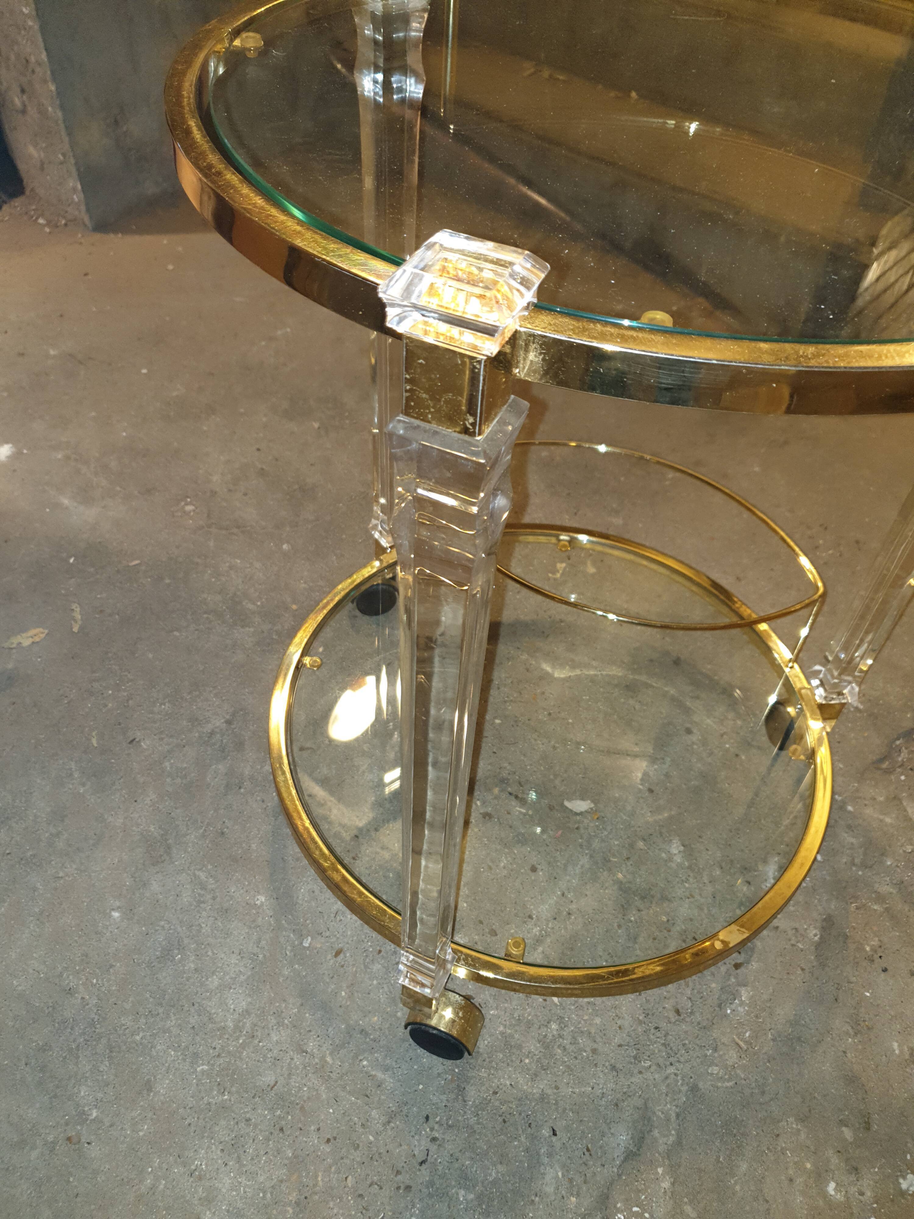 Round table in glass and brass and acrylic columns, 1980