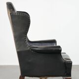 Antique black English cow leather wingback armchair from the 19th century