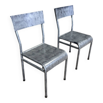 Pair of gray metal industrial chairs