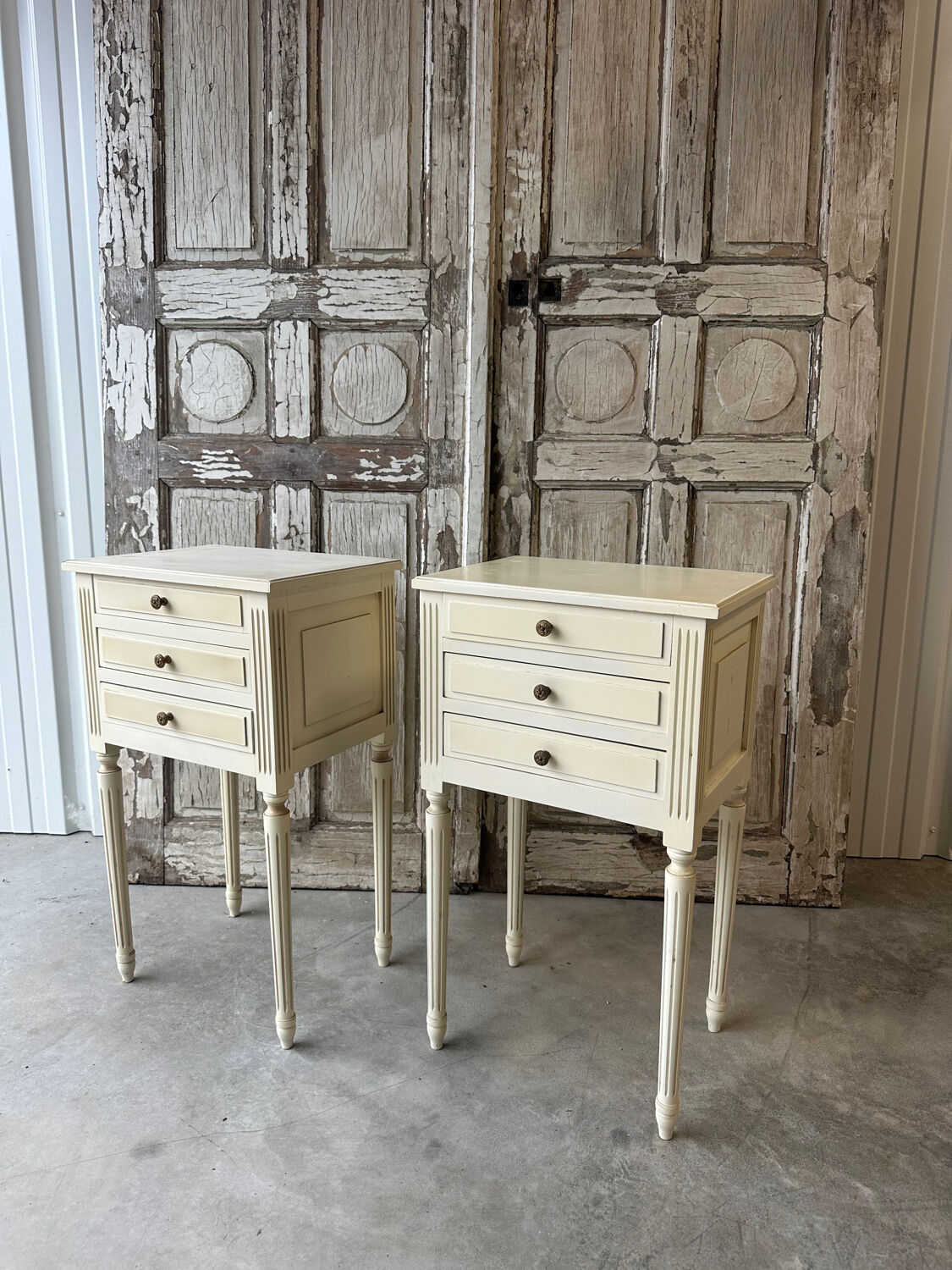 Pair of Louis XVI style bedside tables in white lacquered wood