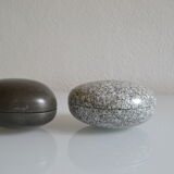2 boxes in lithographed sheet metal in the shape of a pebble