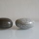 2 boxes in lithographed sheet metal in the shape of a pebble