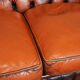 Chesterfield sofa in patinated orange leather, 2.5 seats