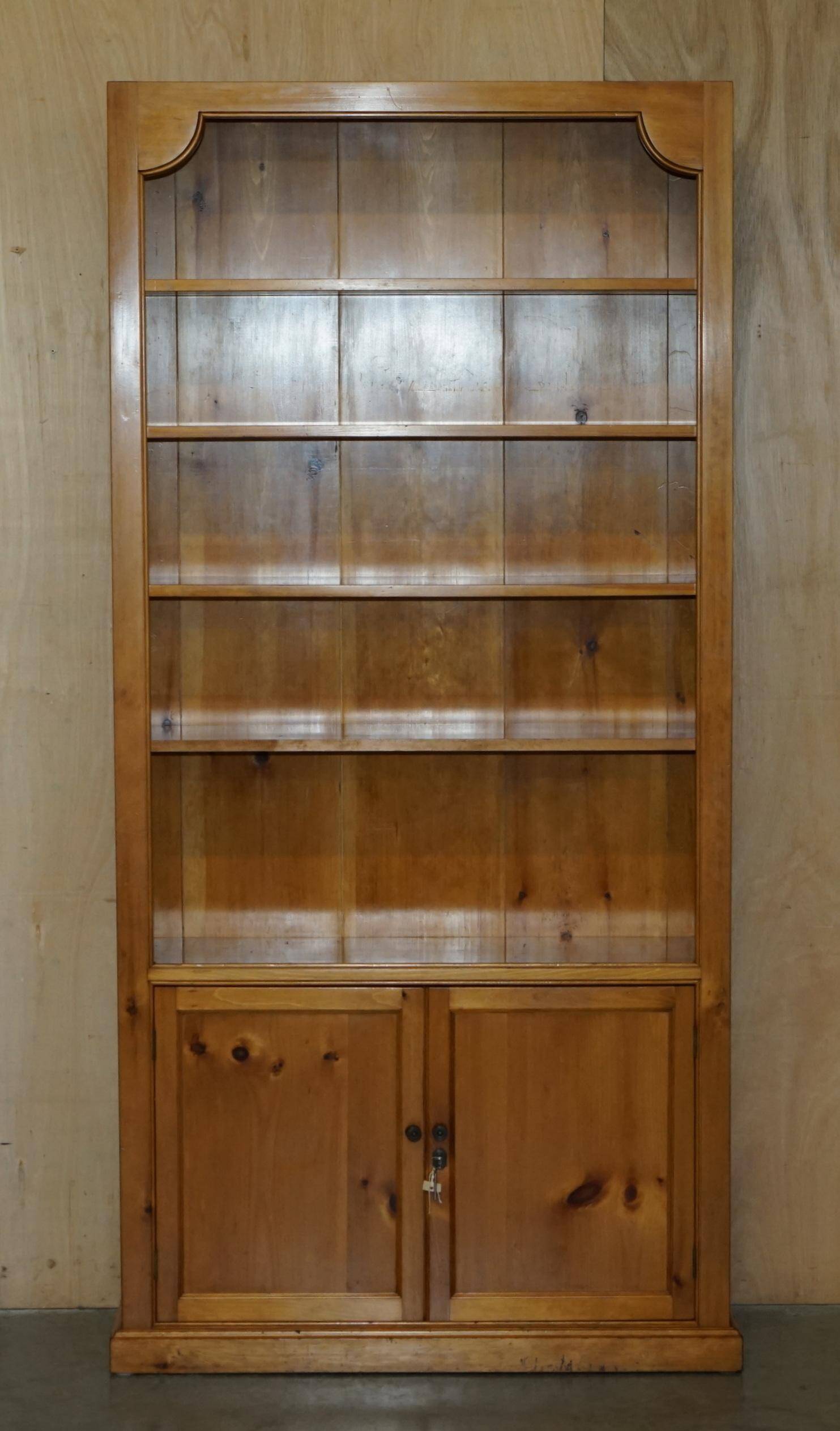 Pair of vintage cherry wood bookcases with lockable doors.