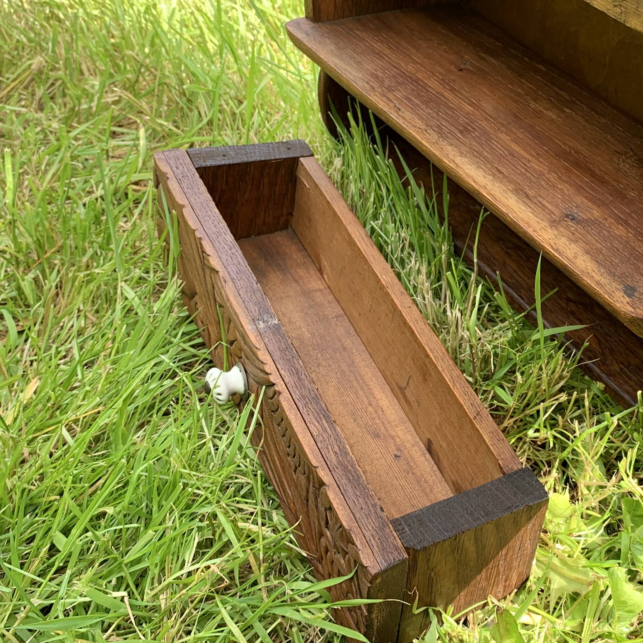 Old carved wooden medicine cabinet with beveled mirror