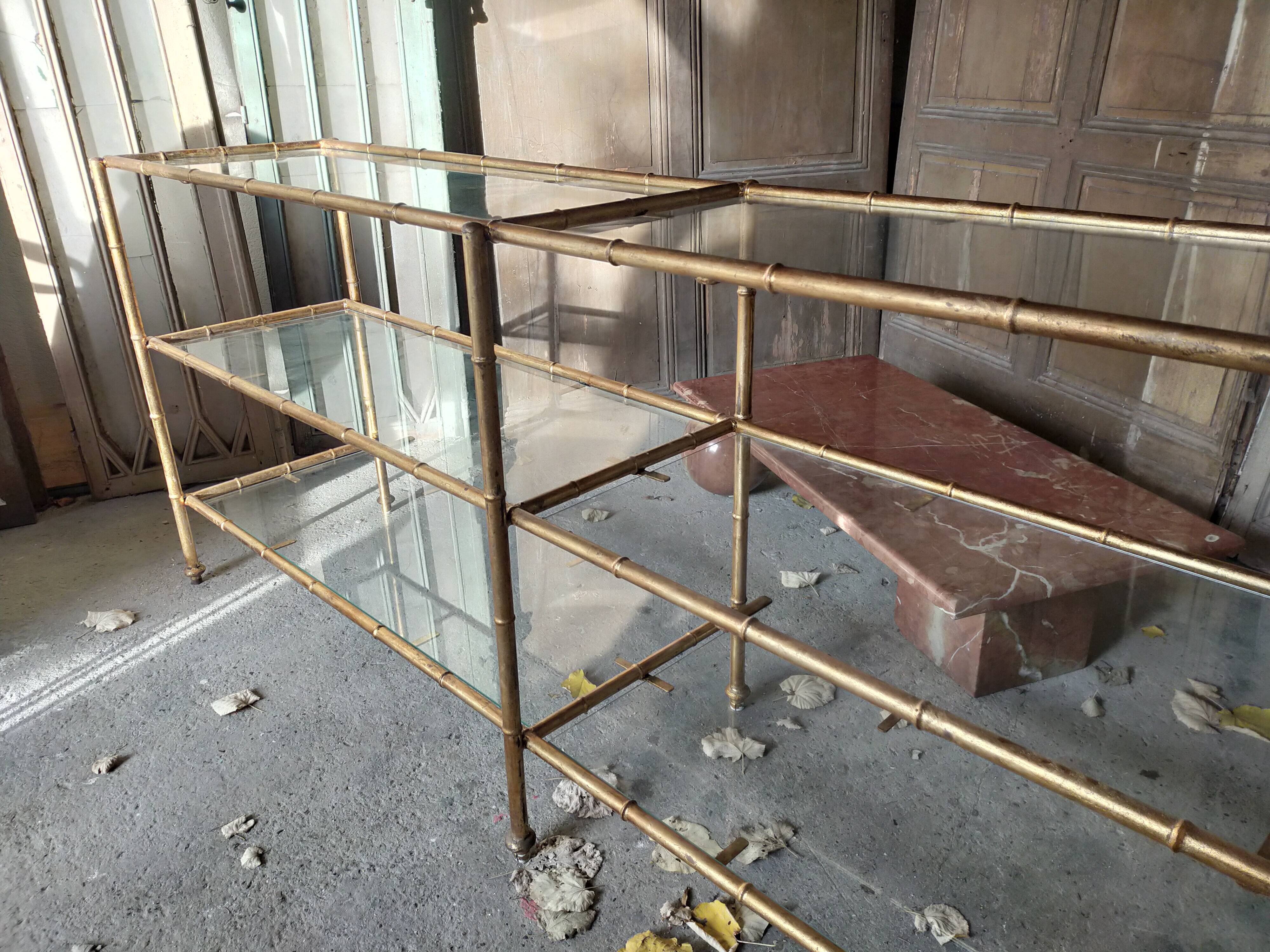 Console in gilded metal and glass