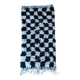 Small Berber rug with black tiles.