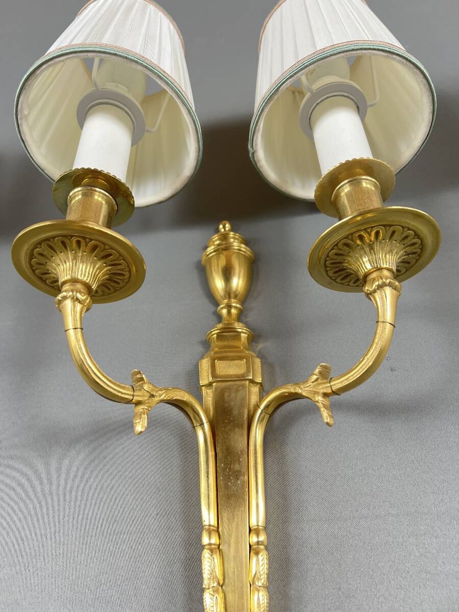 Set of three Louis XVI style wall sconces in gilded bronze, 20th century.
