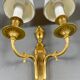 Set of three Louis XVI style wall sconces in gilded bronze, 20th century.