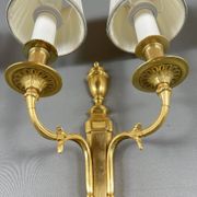 Set of three Louis XVI style wall sconces in gilded bronze, 20th century.