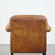 Sheepskin Art Deco design armchair with sleek finish and black piping