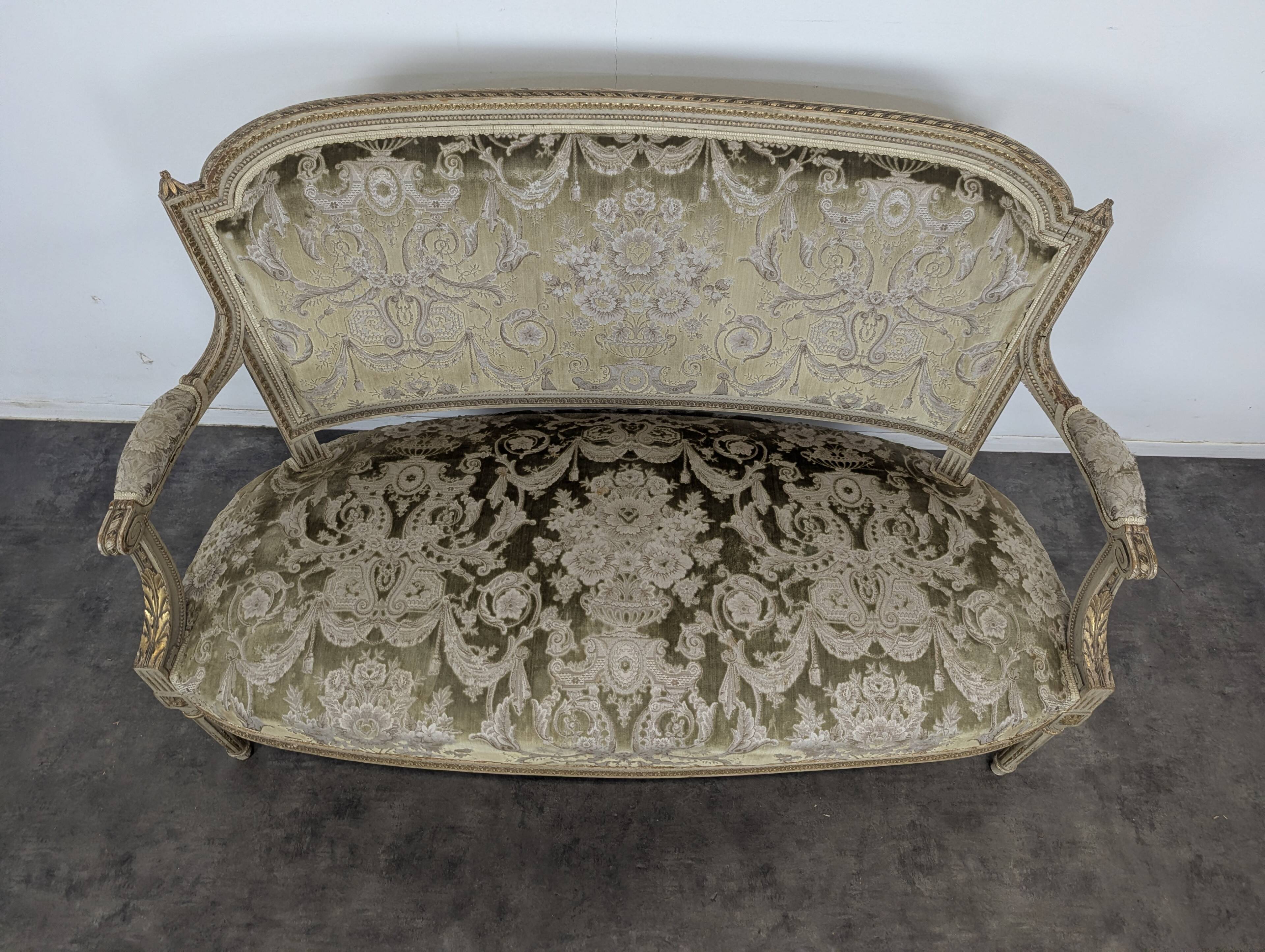 Cream lacquered Louis XVI style cabriolet salon with gold highlights.