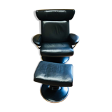 Black leather armchair stressless model jazz and its footrest