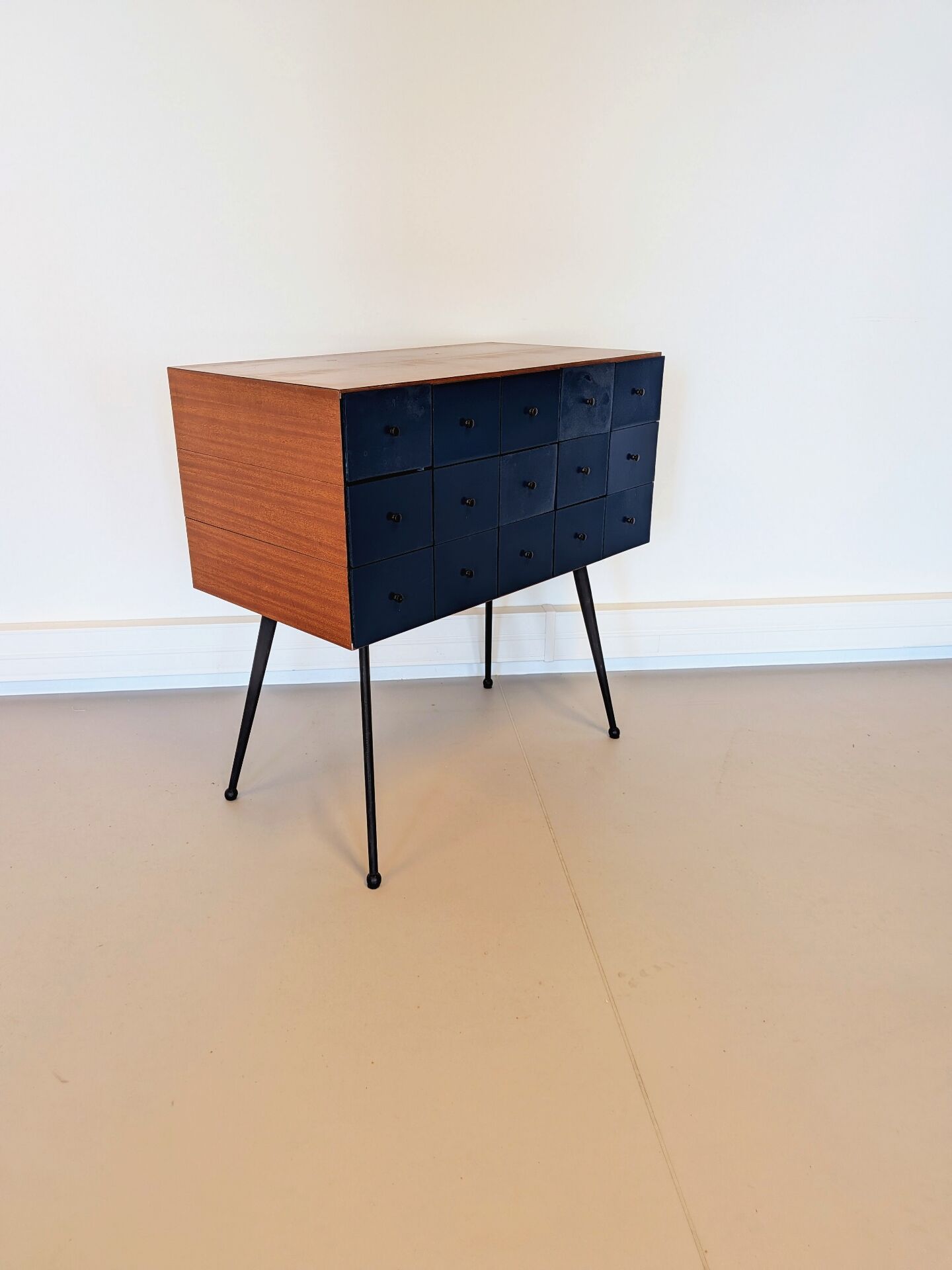 Vintage workshop furniture with 15 blue drawers.