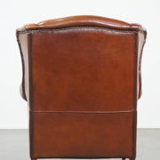 Sheepskin leather wingback chair with patina