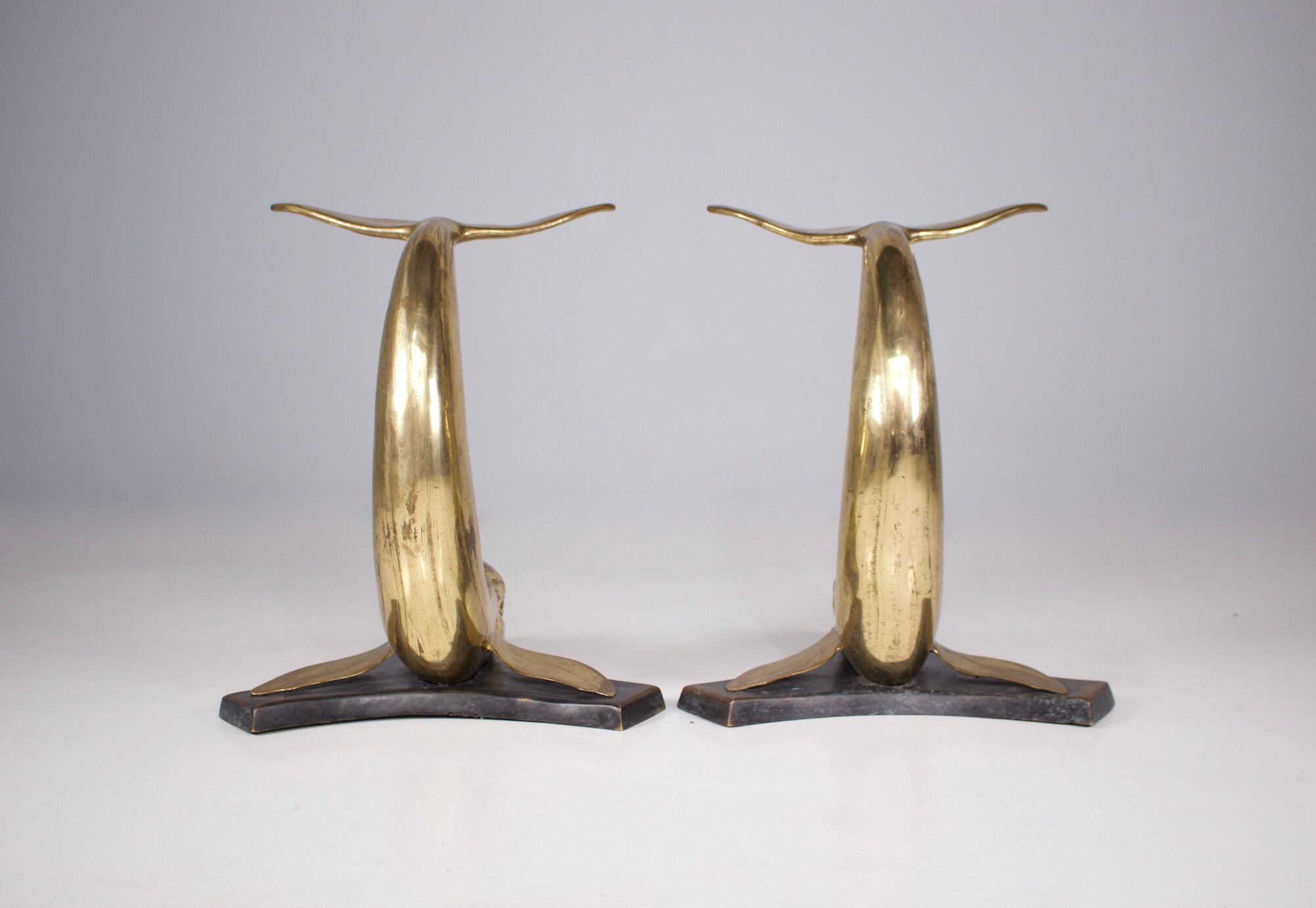 Solid brass dolphin console feet.