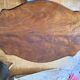 Antique mahogany table with a scalloped top and a sculpted central leg.