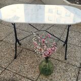 White and black oval marble table, wrought iron base