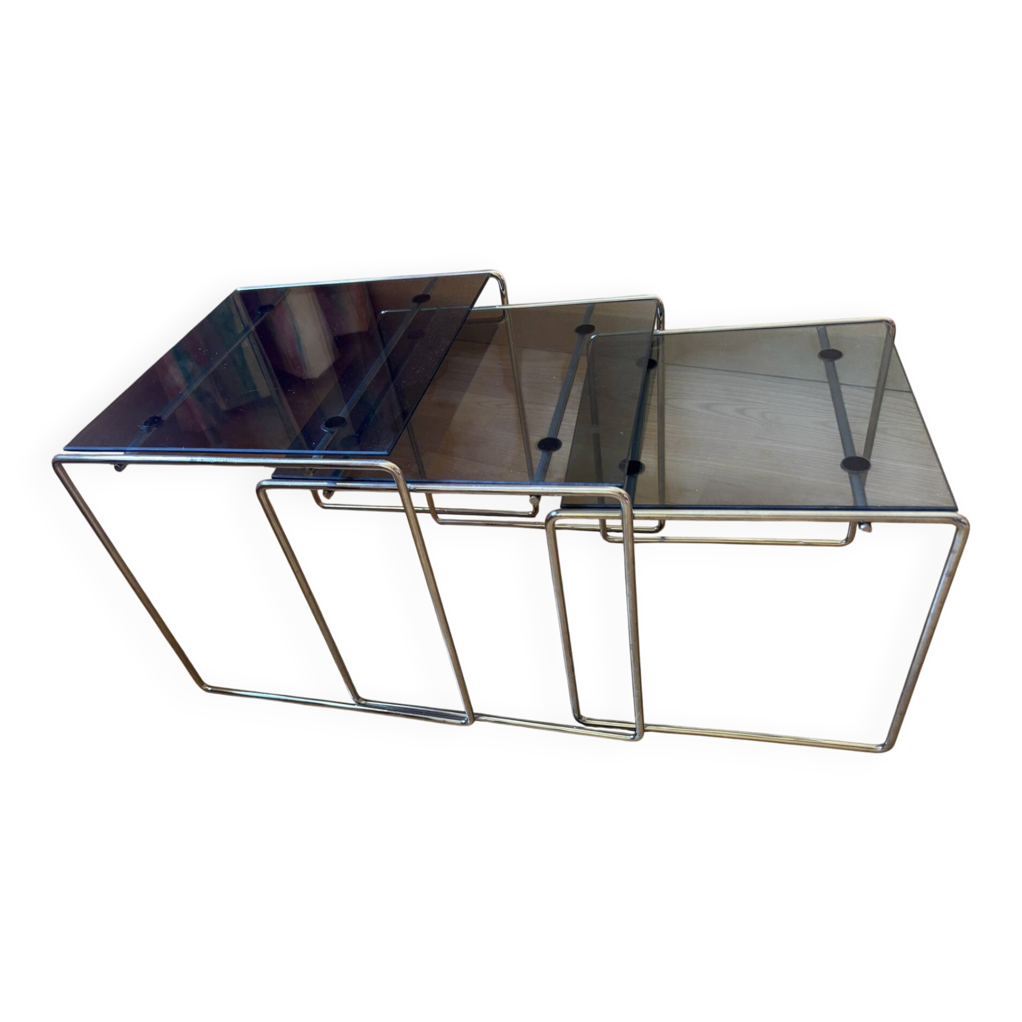 Nest of coffee tables in glass and metal.