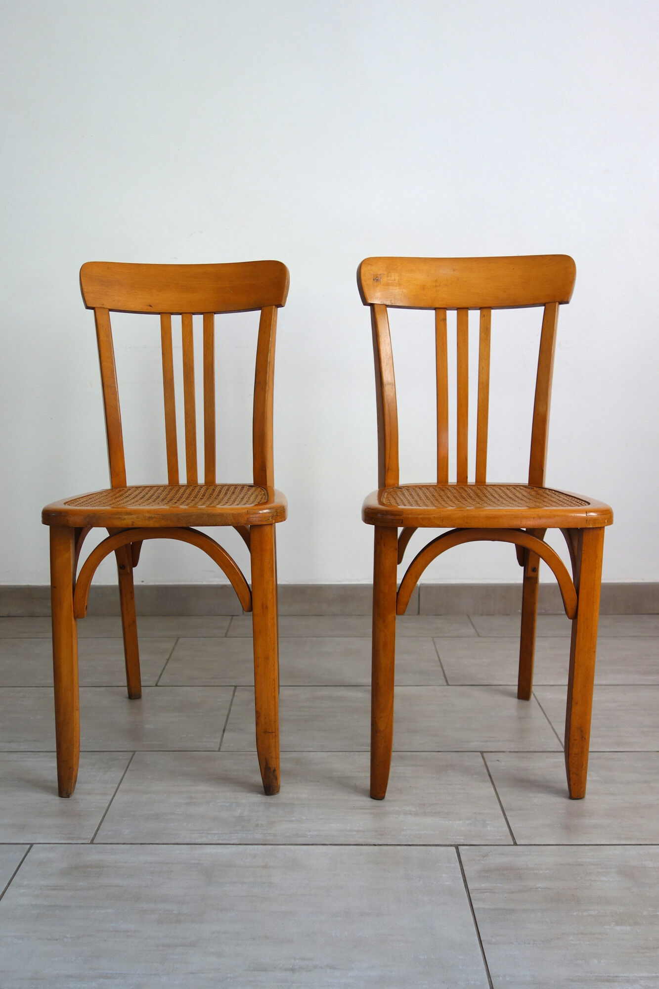Pair of stella caned bistro chairs, 1930s
