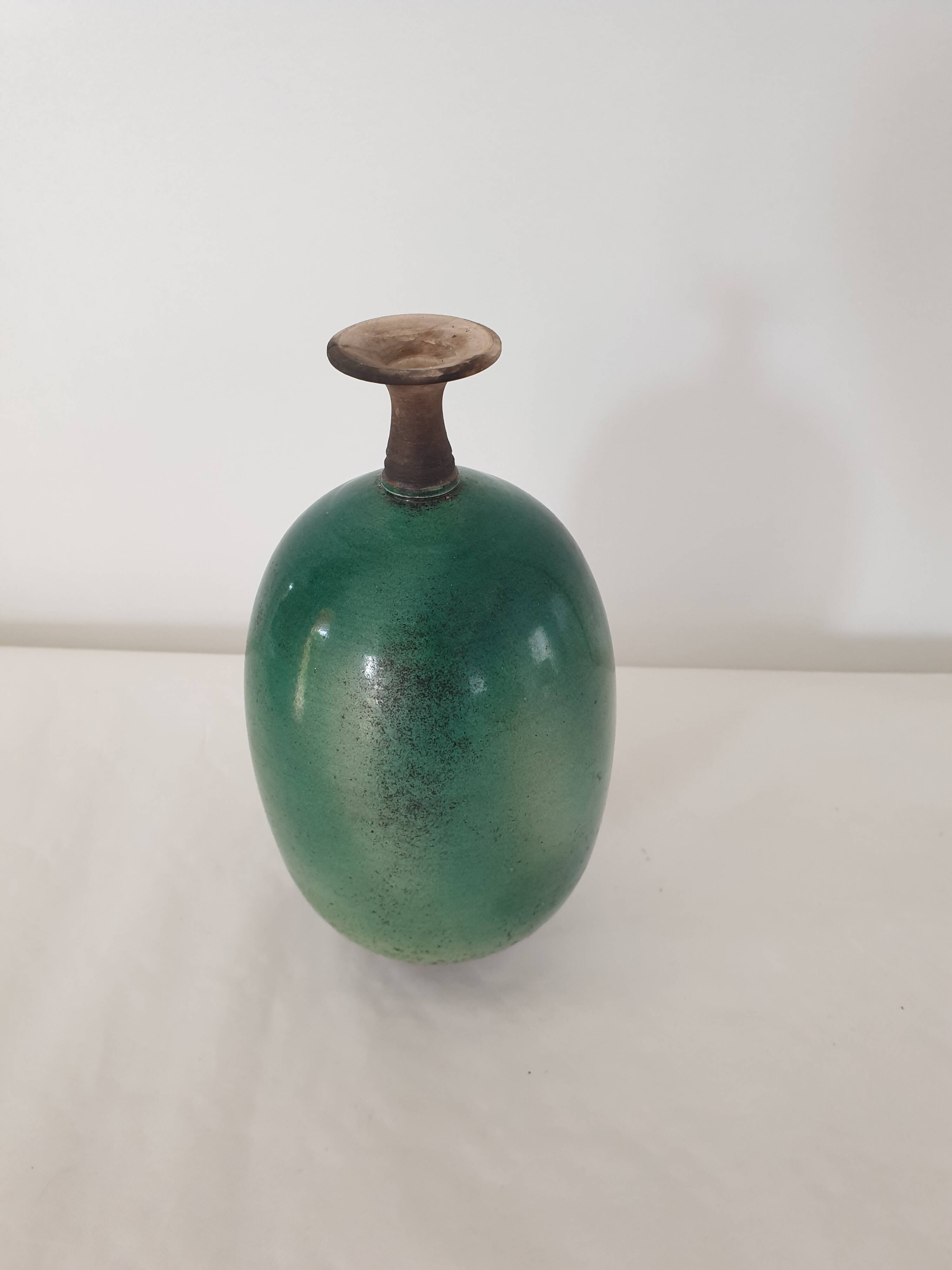 Green pot-bellied ceramic vase with foot and high, narrow neck in signed raku