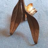 Flower of lilies wears golden 60s ashtrays