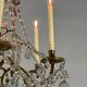 Golden bronze chandelier trimmed with drop-shaped grapevines