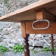 Vintage pine table with drop-leaf extension and turned beech legs, France, 1930s.