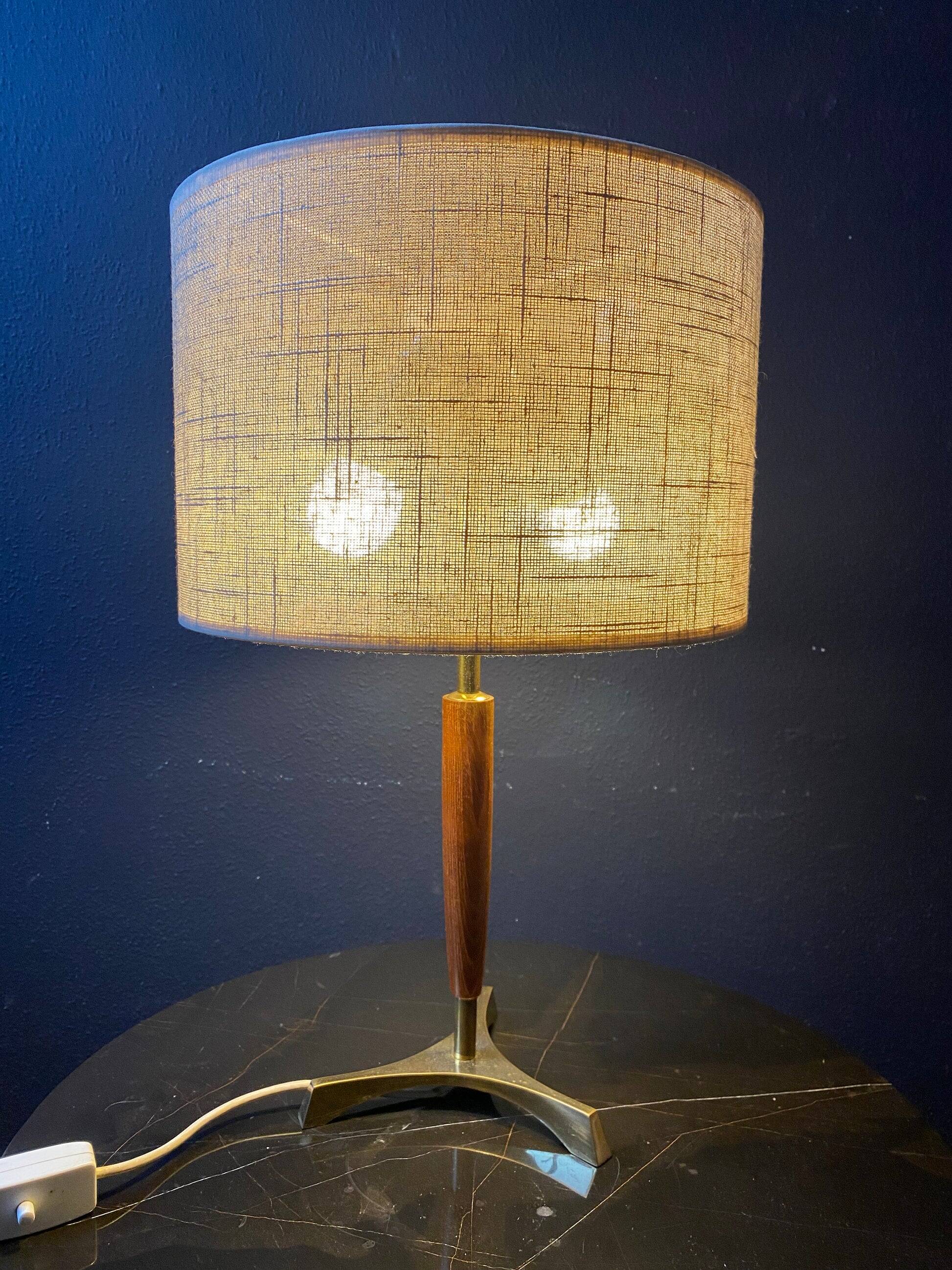 Elegant table lamp with a slender teak body on a tripod brass base, Germany, 1960s.
