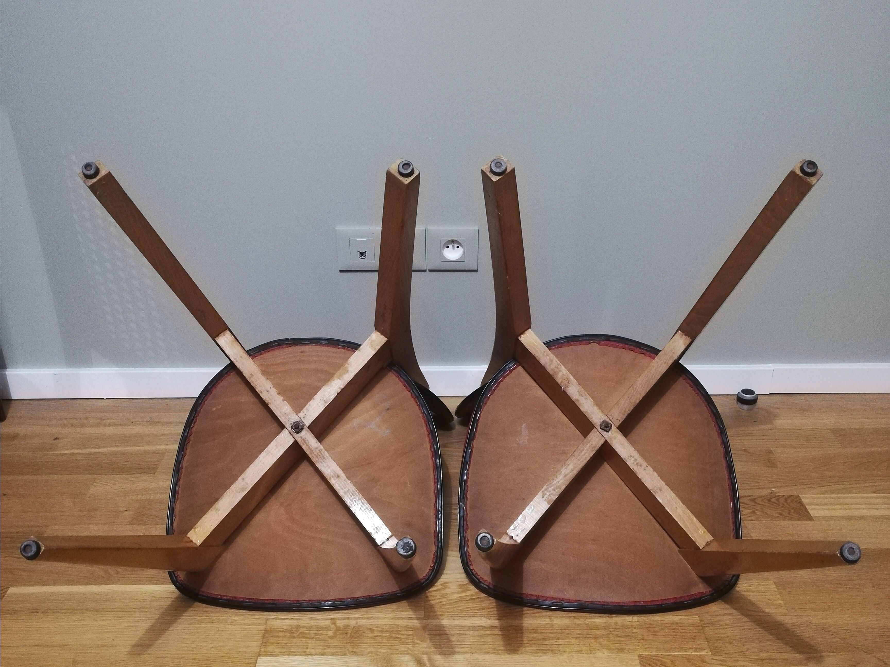 Two vintage chairs wood and mottled red vinyl