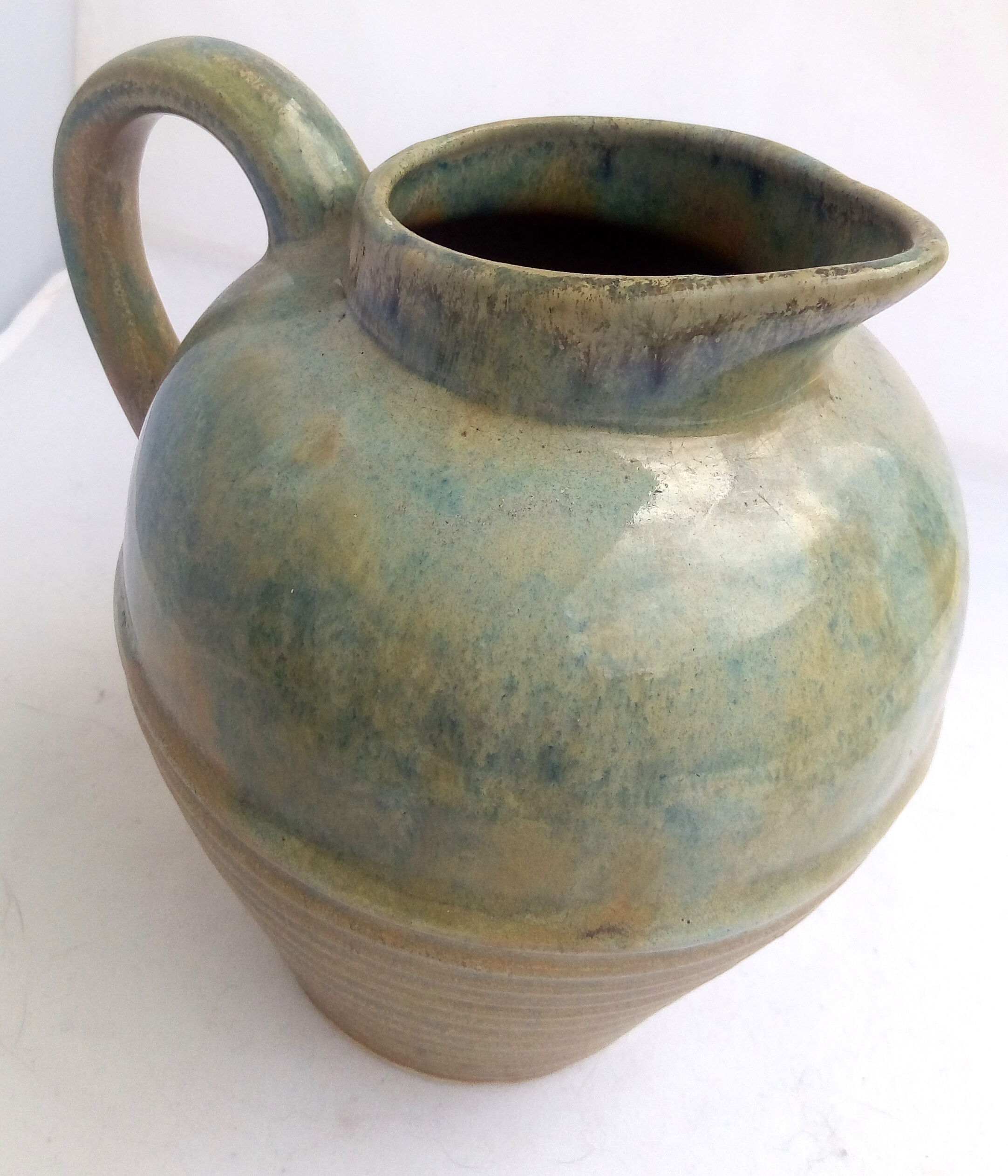 Blue enamelled sandstone pitcher and ochre streaks