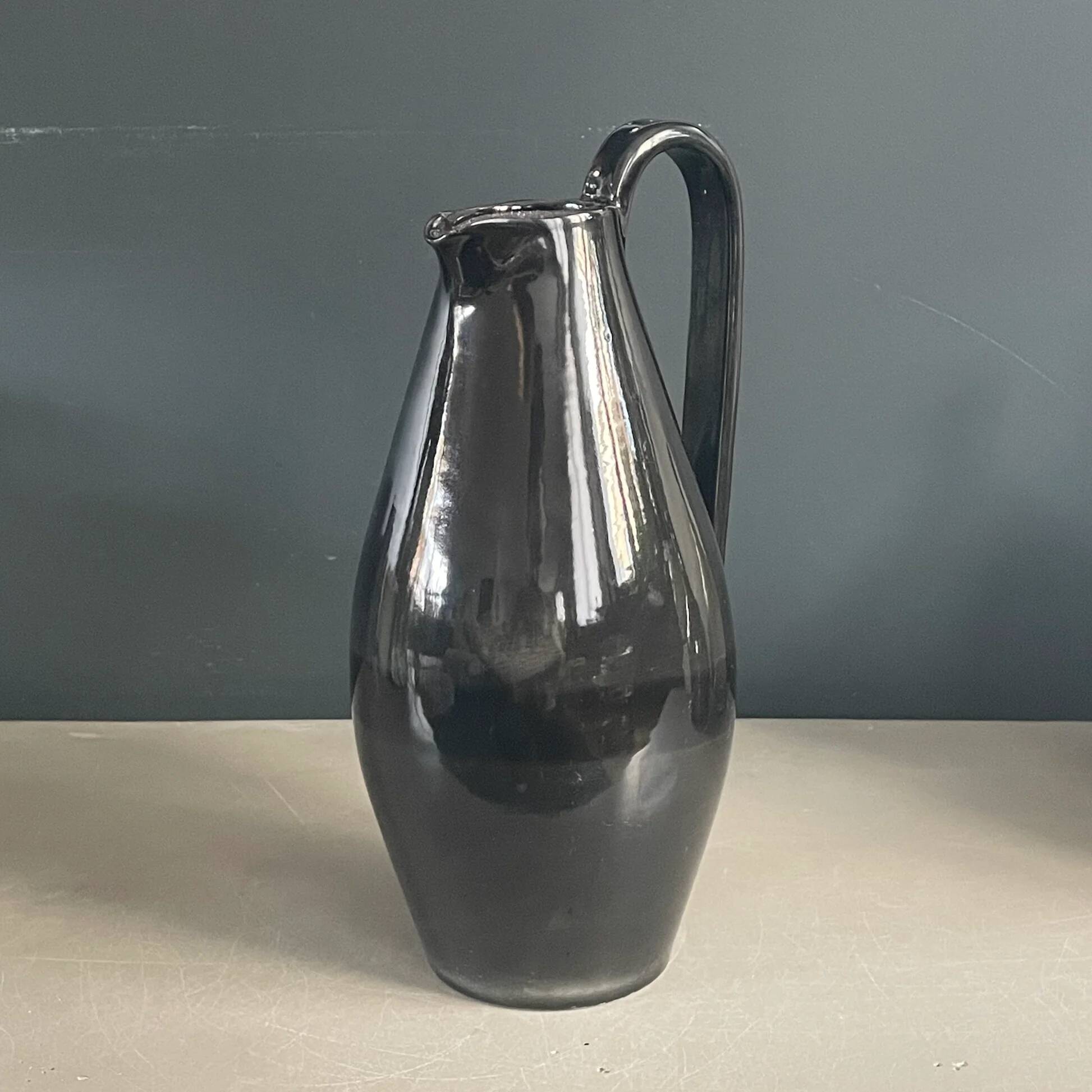 Black glazed ceramic pitcher signed M Azouit