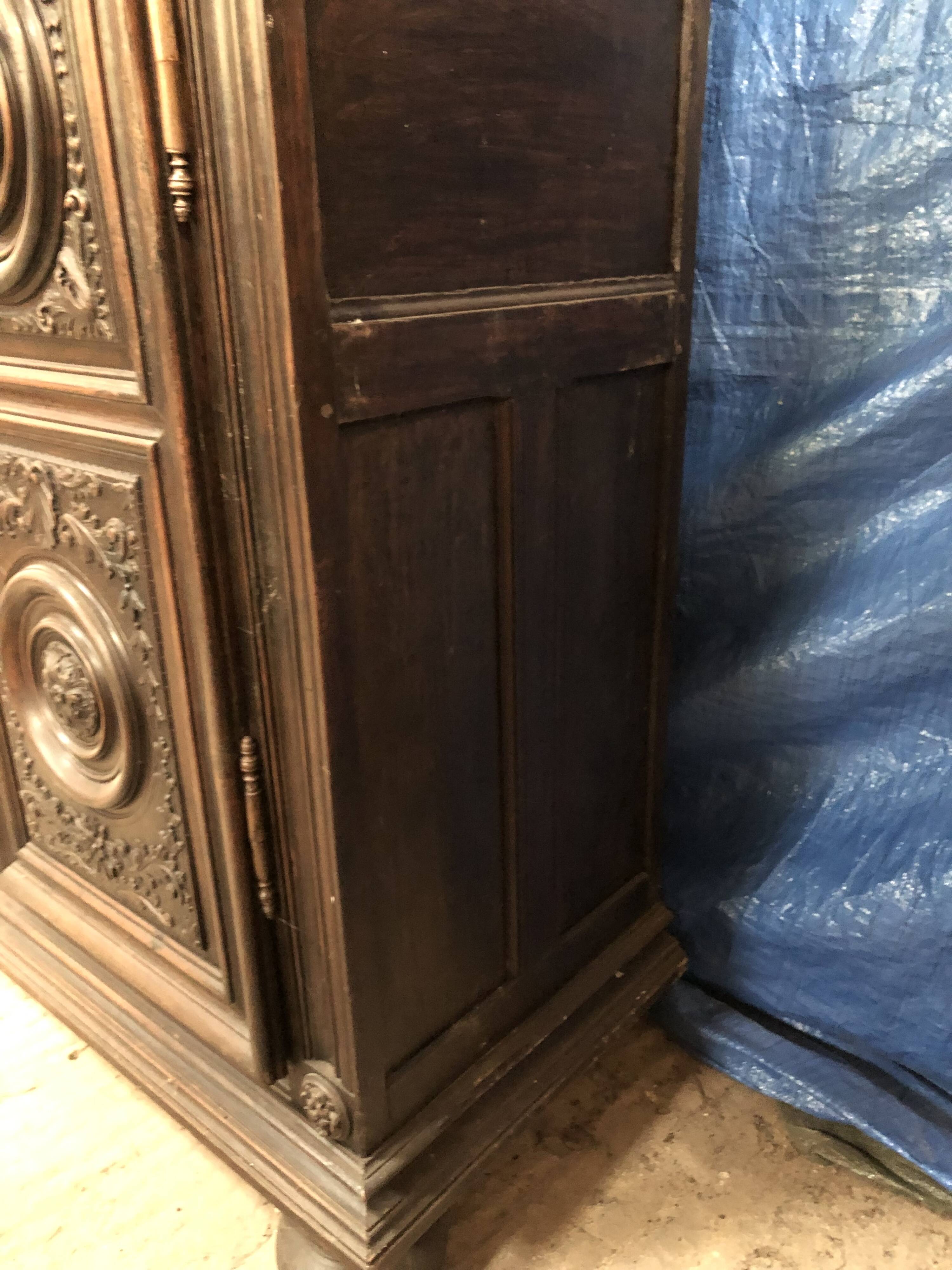 Antique Louis XIII armoire in solid walnut with carved doors
