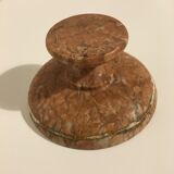 Empty pocket on foot in red marble