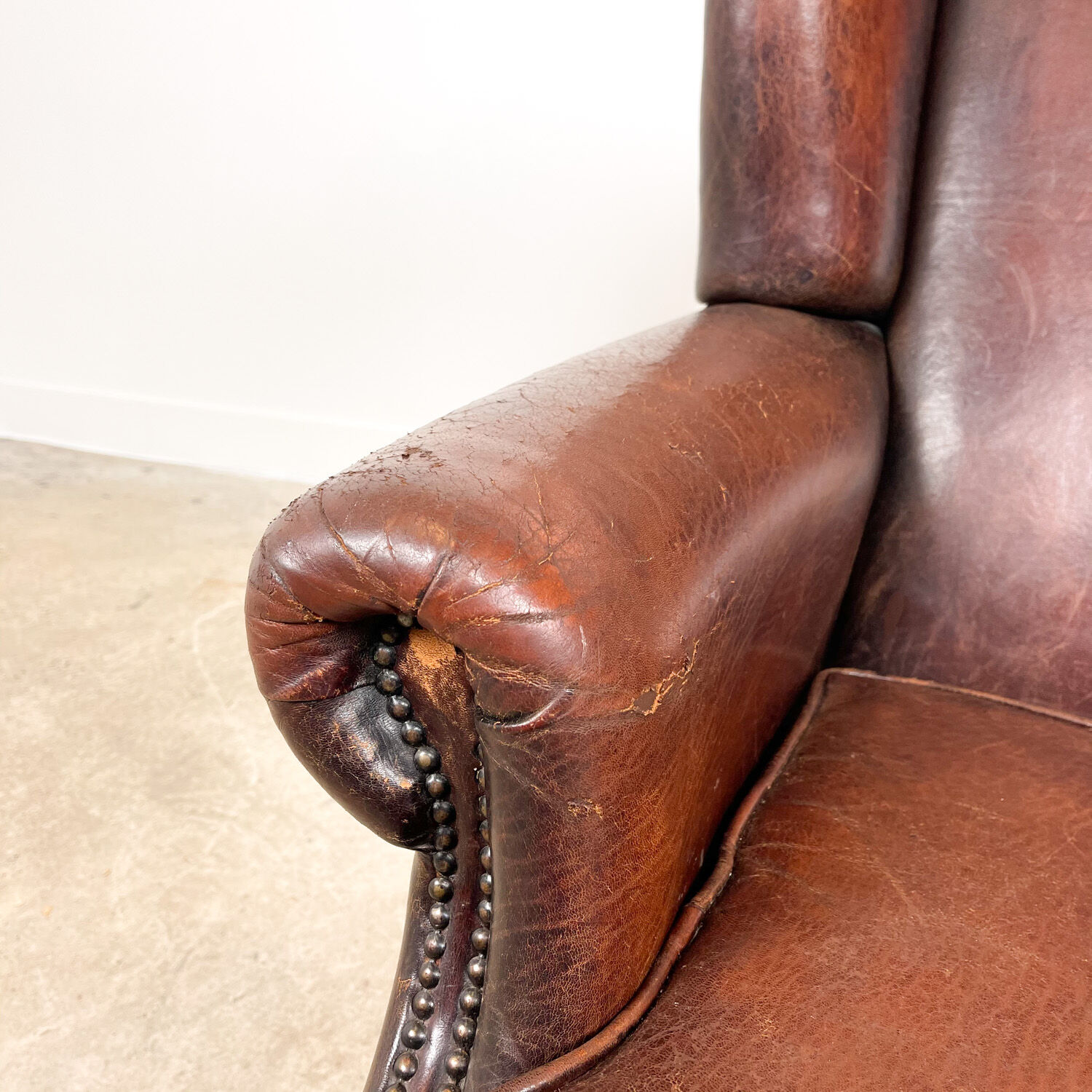 Dark brown vintage sheep leather wingback armchair