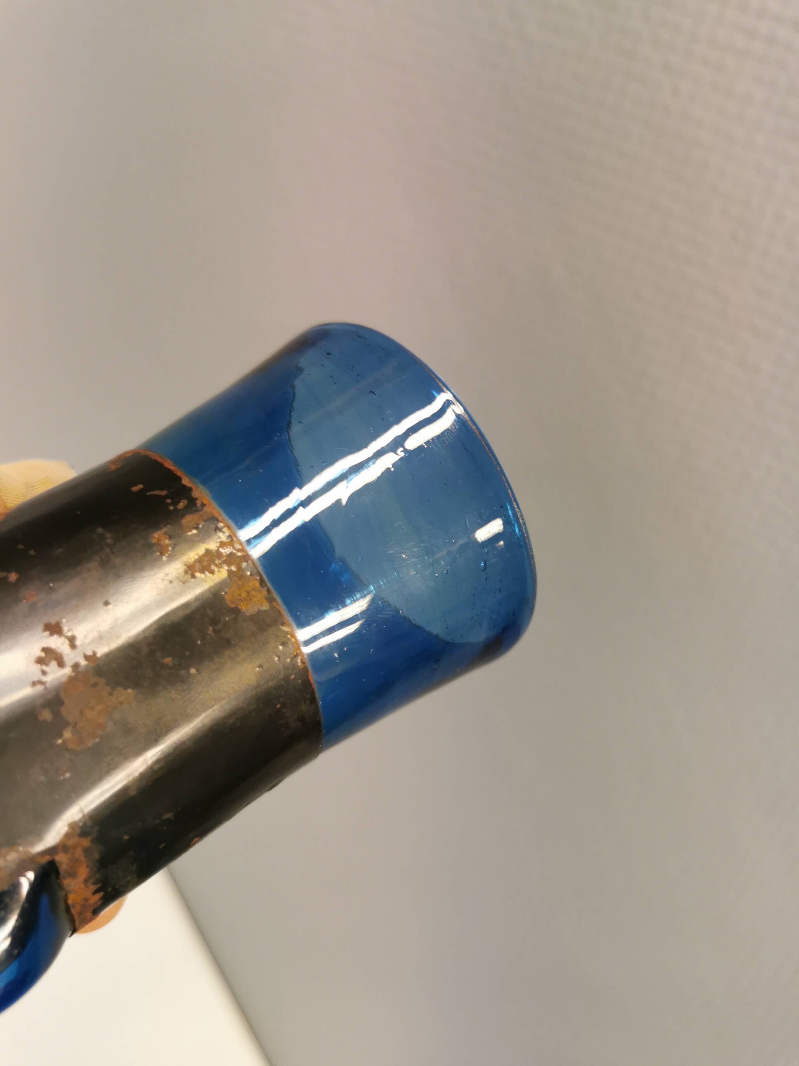 Brutalist style vase with inner blue glass mouth-blown out through the metal "frame".