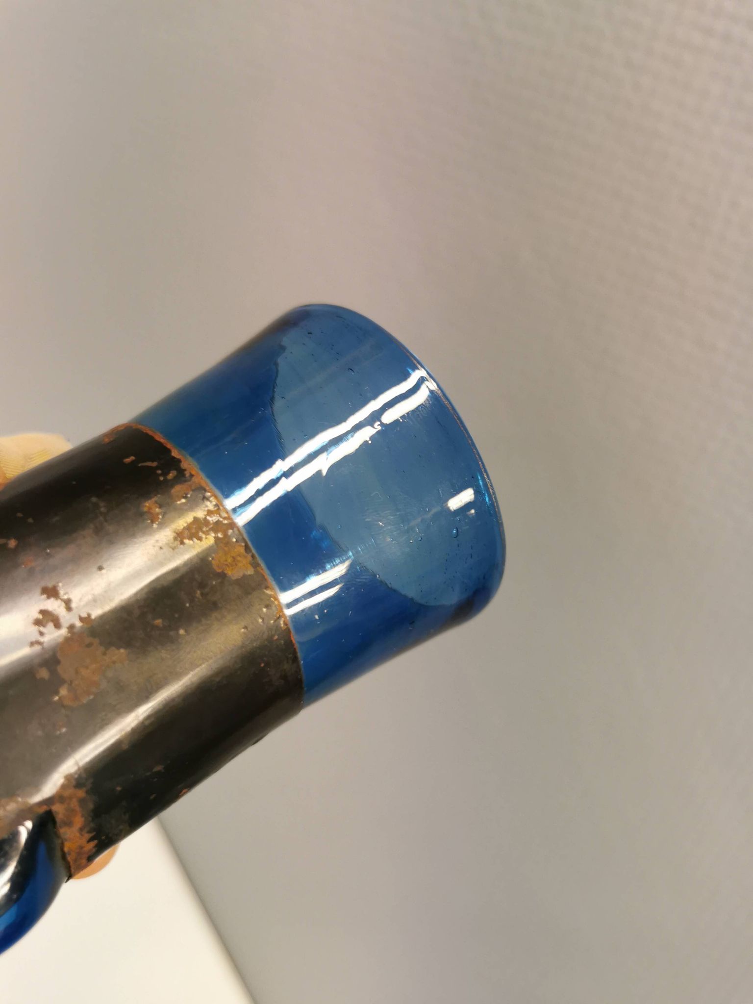 Brutalist style vase with inner blue glass mouth-blown out through the metal "frame".
