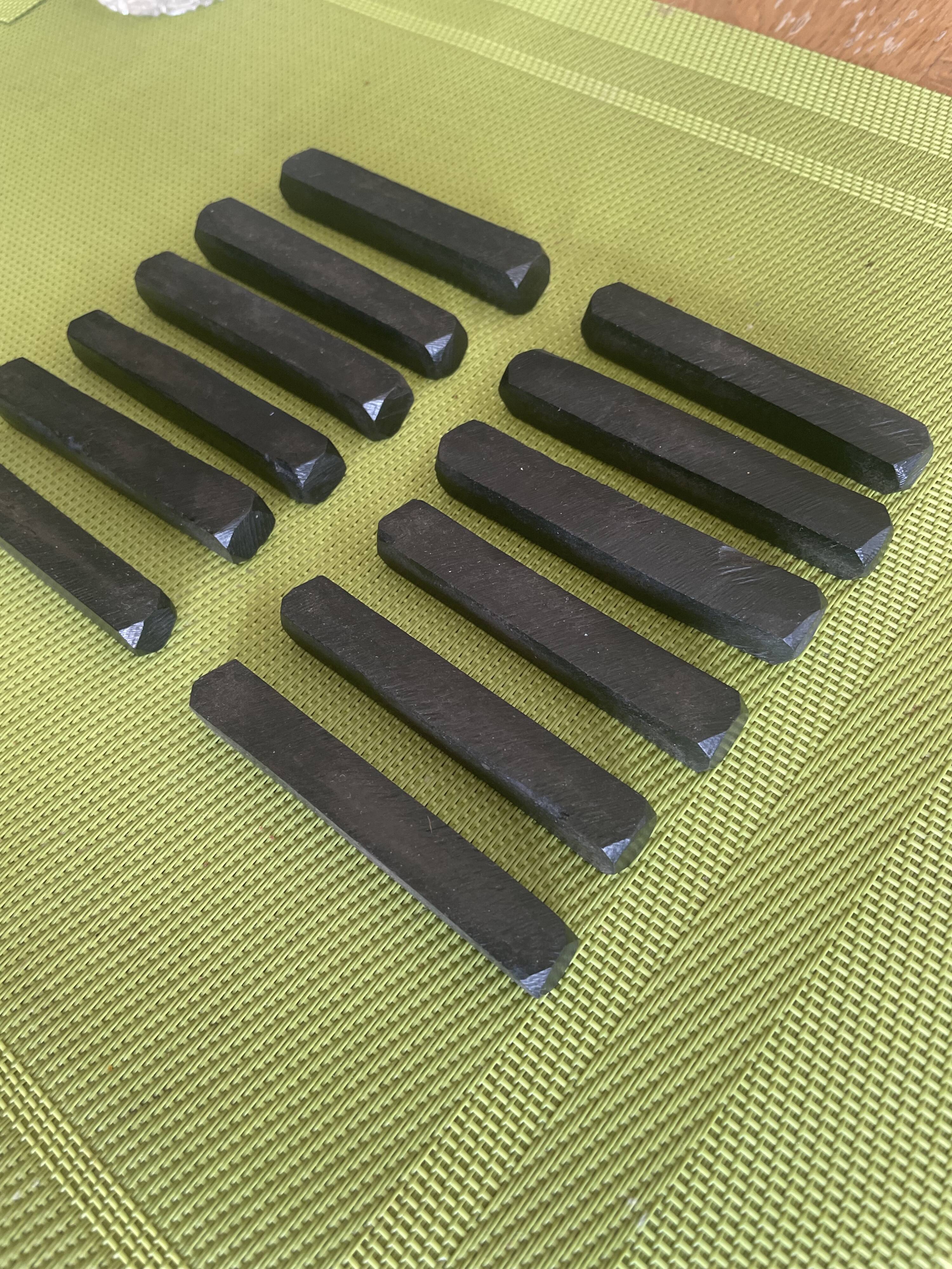 Set of 12 vintage ebony knife rests