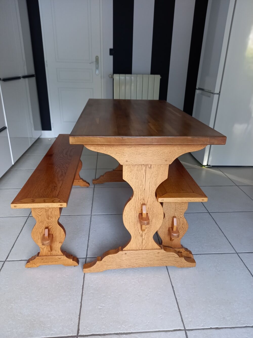 Solid oak table and its two benches made by a craftsman.