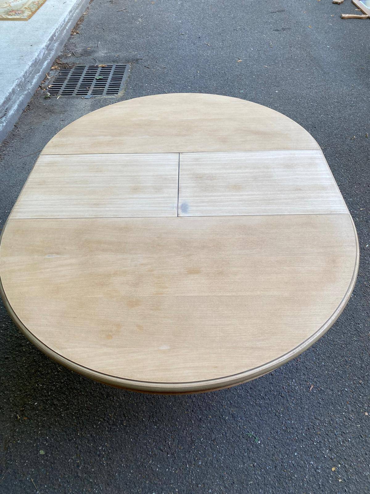 Extendable round dining table with central art deco leg, renovated in raw wood